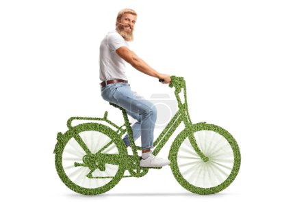Photo for Bearded guy with moustaches riding a green eco bicycle and smiling at camera isolated on white background - Royalty Free Image