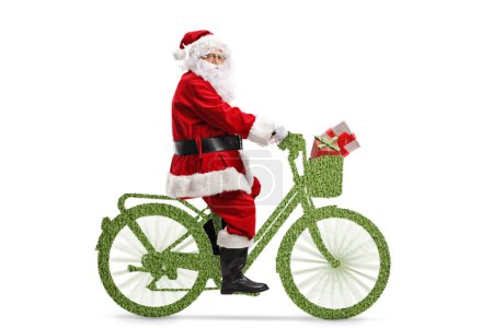 Photo for Full length shot of Santa Claus riding a green bicycle isolated on white background - Royalty Free Image