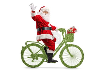 Foto de Foto de perfil completo de Santa Claus montando una eco bicicleta verde, concepto de movilidad sostenible - Imagen libre de derechos