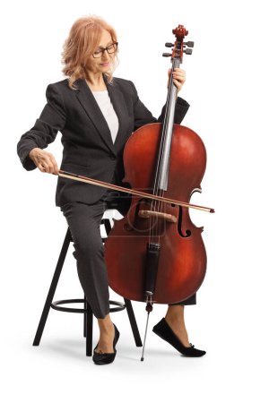 Photo for Female musician sitting and playing a cello isolated on white background - Royalty Free Image