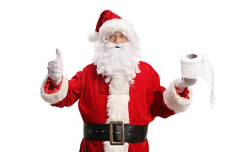 Foto de Santa Claus sosteniendo un rollo de papel higiénico y haciendo gestos con los pulgares hacia arriba aislados sobre fondo blanco - Imagen libre de derechos