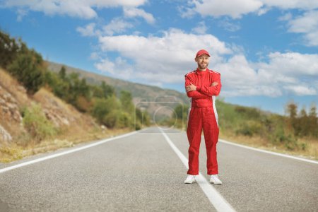 Photo for Racer in a red suit standing on an open road - Royalty Free Image