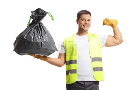 Foto de Colector de residuos en uniforme y guantes que sostienen una bolsa de basura y muestran músculos aislados sobre fondo blanco - Imagen libre de derechos