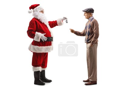 Photo for Full length profile shot of santa claus giving car key to an elderly man isolated on white background - Royalty Free Image