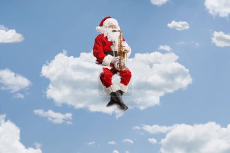 Photo for Santa Claus playing saxophone and sitting on a cloud up in the sky - Royalty Free Image