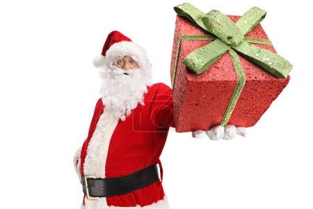 Photo for Santa claus holding a glittery red gift box isolated on white background - Royalty Free Image