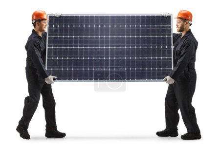 Foto de Trabajadores de la fábrica llevando un panel fotovoltaico aislado sobre fondo blanco - Imagen libre de derechos