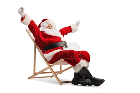 Photo for Excited Santa claus enjoying on a deck chair isolated on white background - Royalty Free Image