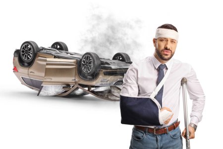 Photo for Injured driver after a car accident standing in front of a SUV turned upside down isolated on white background - Royalty Free Image