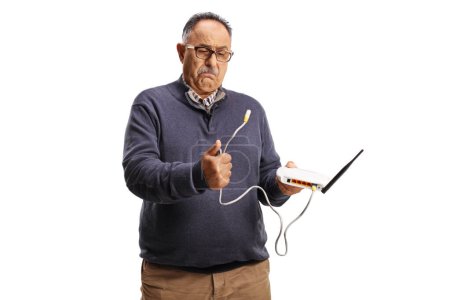 Photo for Confused mature man holding a router cable isolated on white background - Royalty Free Image