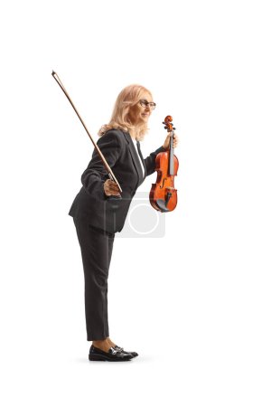 Photo for Full length shot of a female musician holding a violin and a fiddle and bowing isolated on white background - Royalty Free Image