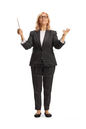Photo for Full length portrait of a woman conductor directing a musical performance isolated on white background - Royalty Free Image