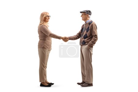 Photo for Full length profile shot of an elderly man shaking hand with a woman isolated on white background - Royalty Free Image