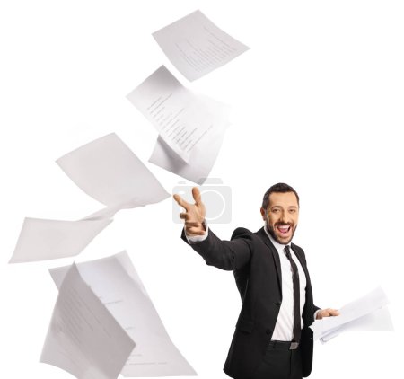 Photo for Smiling businessman throwing paper in air isolated on white background - Royalty Free Image