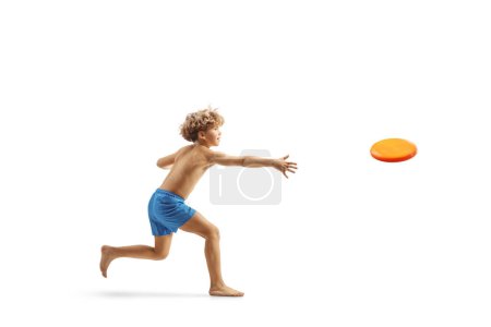 Photo for Boy in swimming shorts throwing a flying disc isolated on white background - Royalty Free Image