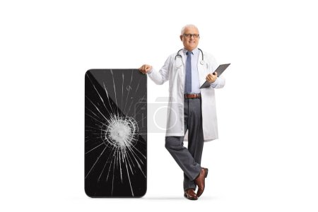 Photo for Doctor leaning on a smartphone with a cracked screen isolated on white background - Royalty Free Image