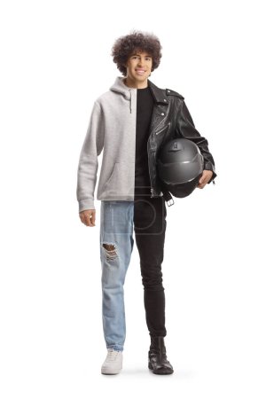 Foto de Joven dividido en dos, mitad en ropa casual, mitad en una chaqueta de cuero sosteniendo un casco aislado sobre fondo blanco - Imagen libre de derechos