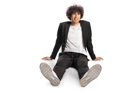 Photo for Young man with curly hair sitting on the floor isolated on white background - Royalty Free Image
