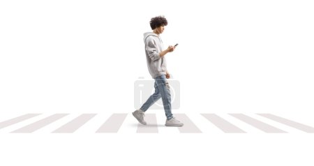 Photo for Young man wearing a gray hoodie and crossing a street with a smartphone isolated on white background - Royalty Free Image