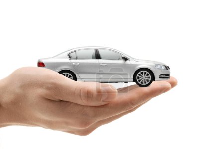 Photo for Male hand holding a small silver car isolated on white background - Royalty Free Image