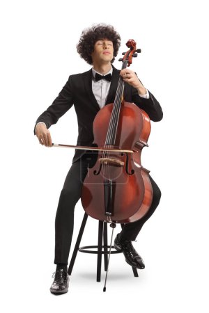 Téléchargez les photos : Young cellist sitting on a chair and playing isolated on white background - en image libre de droit