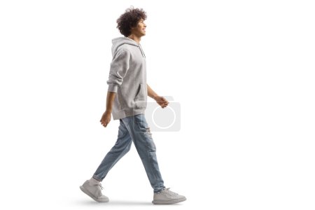 Téléchargez les photos : Full length portrait of a tall guy with curly hair walking isolated on white background - en image libre de droit