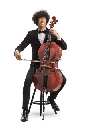 Photo for Young man sitting on a chair with a chello and a fiddle isolated on white background - Royalty Free Image