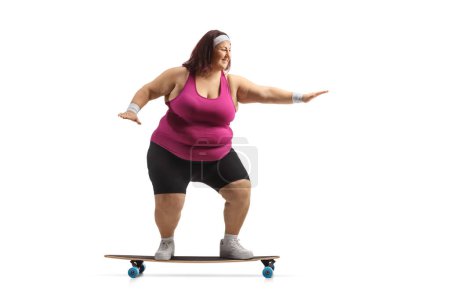 Photo for Corpulent woman in sportswear riding a skateboard isolated on white background - Royalty Free Image