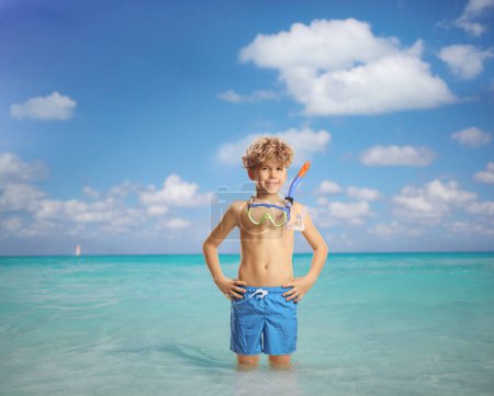 Photo for Boy with a dive mask standing inside a sea - Royalty Free Image
