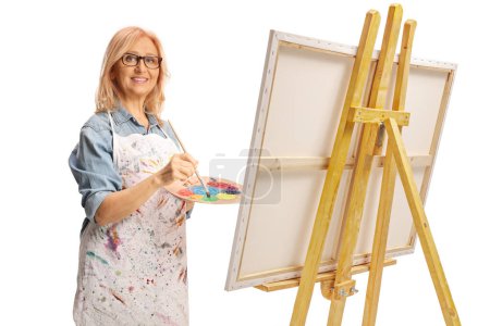 Photo for Woman with an apron painting on a canvas isolated on white background - Royalty Free Image