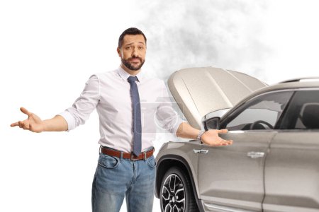 Photo for Angry driver standing in front of a SUV with an open hood isolated on white background - Royalty Free Image