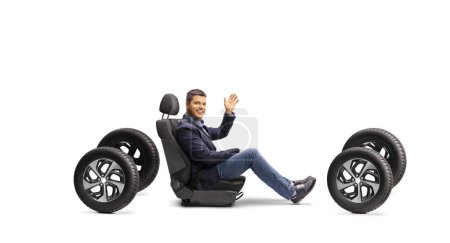 Photo for Man in a car seat on four tires waving at camera isolated on white background - Royalty Free Image