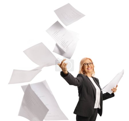 Photo for Happy middle aged woman throwing paper documents and smiling isolated on white background - Royalty Free Image