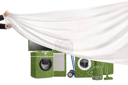 Foto de Manos masculinas tirando de un trozo blanco de tela frente a electrodomésticos energéticamente eficientes aislados sobre fondo blanco - Imagen libre de derechos