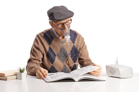 Photo for Elderly man using a nebulizer and reading a book isolated on white background - Royalty Free Image