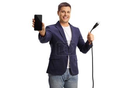 Photo for Man holding an electric cable with a plug and a smartphone isolated on white background - Royalty Free Image