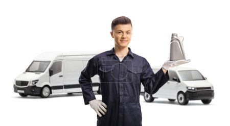 Photo for Mechanic in front of vans holding engine oil bottle isolated on white background - Royalty Free Image