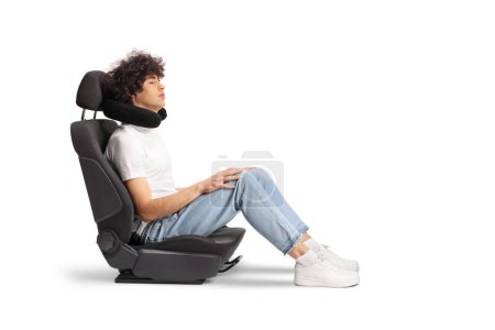 Photo for Guy in a car seat with a travel pillow around neck isolated on white background - Royalty Free Image