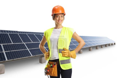 Photo for Solar farm and a female construction worker wearing a helmet and a tool belt isolated on white background - Royalty Free Image