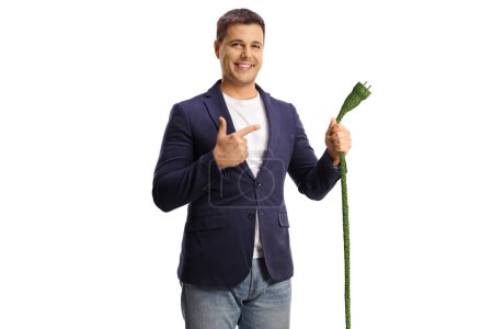 Photo for Happy young man pointing at a green electric cable isolated on white background - Royalty Free Image