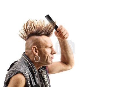 Punk fixing his mohawk hairstyle with a comb isolated on white background