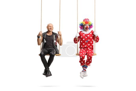 Photo for Punk and a clown swinging on swings isolated on white background - Royalty Free Image