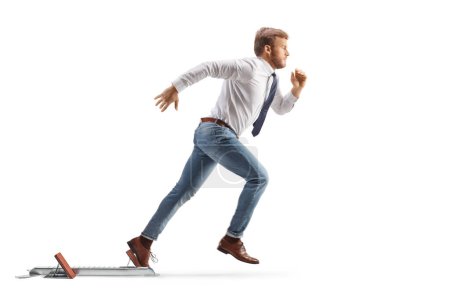 Photo for Full length profile shot of a white collar worker running from starting blocks isolated on white background - Royalty Free Image