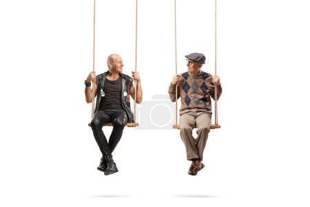 Photo for Punk and an elderly man sitting on swings and looking at each other isolated on white background - Royalty Free Image