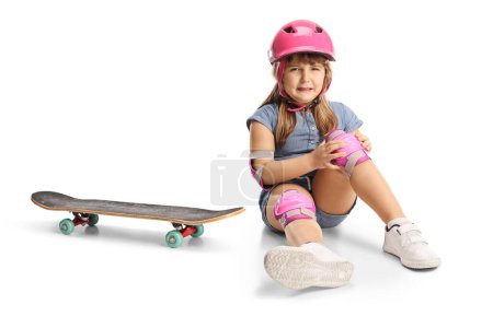 Photo for Girl falling from a skateboard and hurting knee isolated on white background - Royalty Free Image