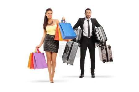 Photo for Full length portrait of a man carrying suitcases and woman walking with shopping bags isolated on white background - Royalty Free Image