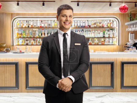 Hotel manager posing at the lobby bar