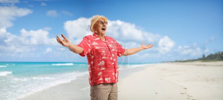 Photo for Overjoyed mature man with a straw hat enjoying the sea breeze on a sandy beach in Cuba - Royalty Free Image
