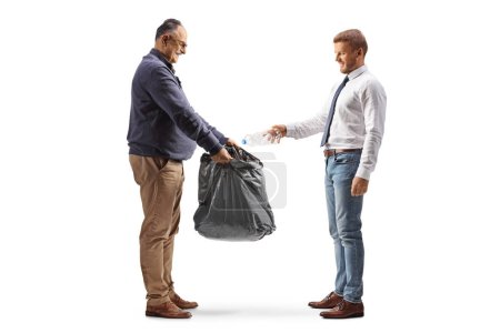 Photo for Mature man holding a waste bag and a businessman throwing a plastic bottle isolated on white background - Royalty Free Image