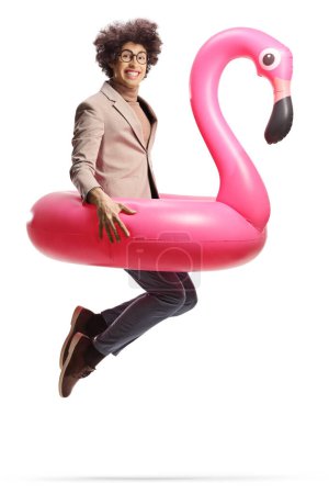 Photo for Man jumping with a big inflatable flamingo rubber ring isolated on white background - Royalty Free Image